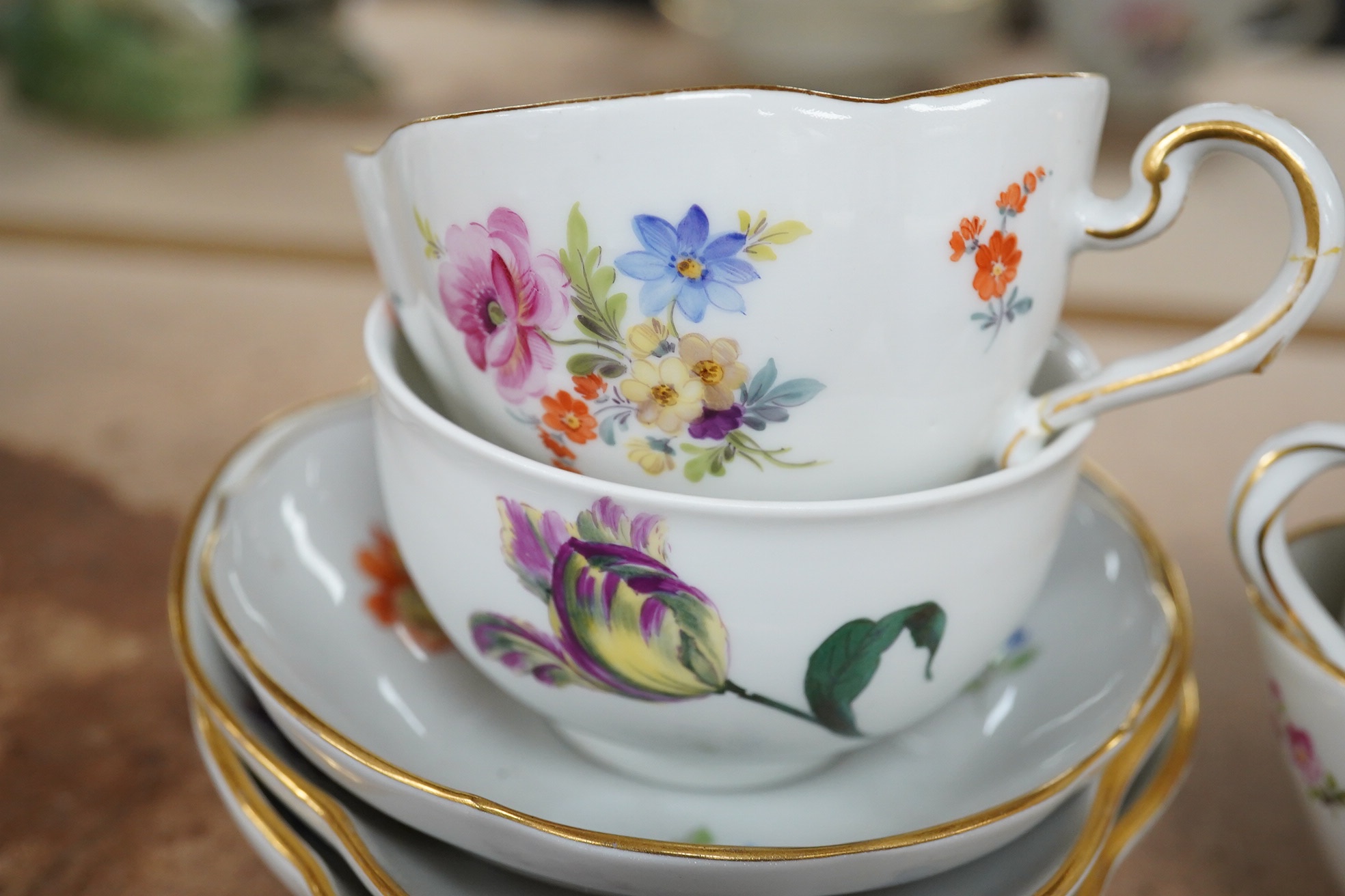 A group of 19th century Meissen porcelain cups and saucers. Condition - one teacup has a re-glued handle